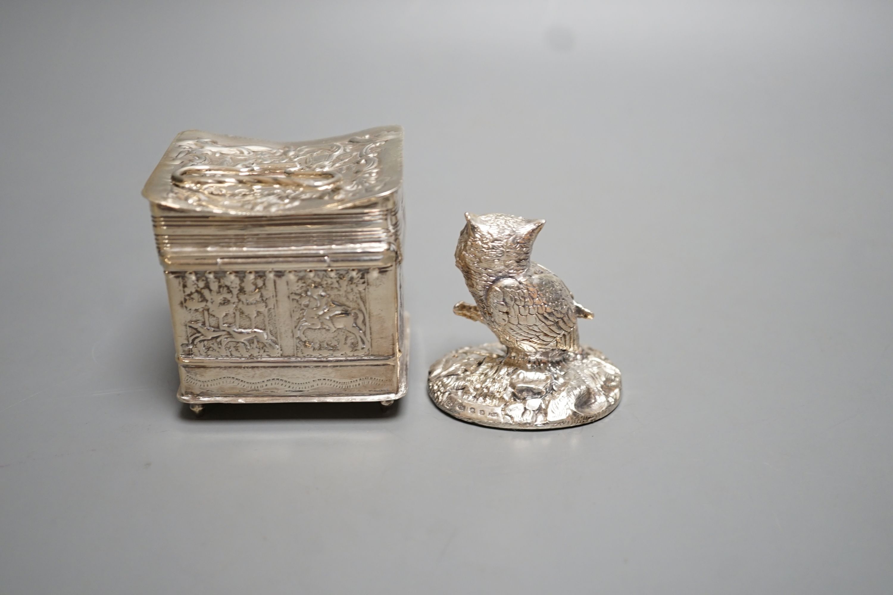 A continental embossed silver box, with import marks for London, 1903, 65mm, a modern silver filled model owl and a metal model of a dog.